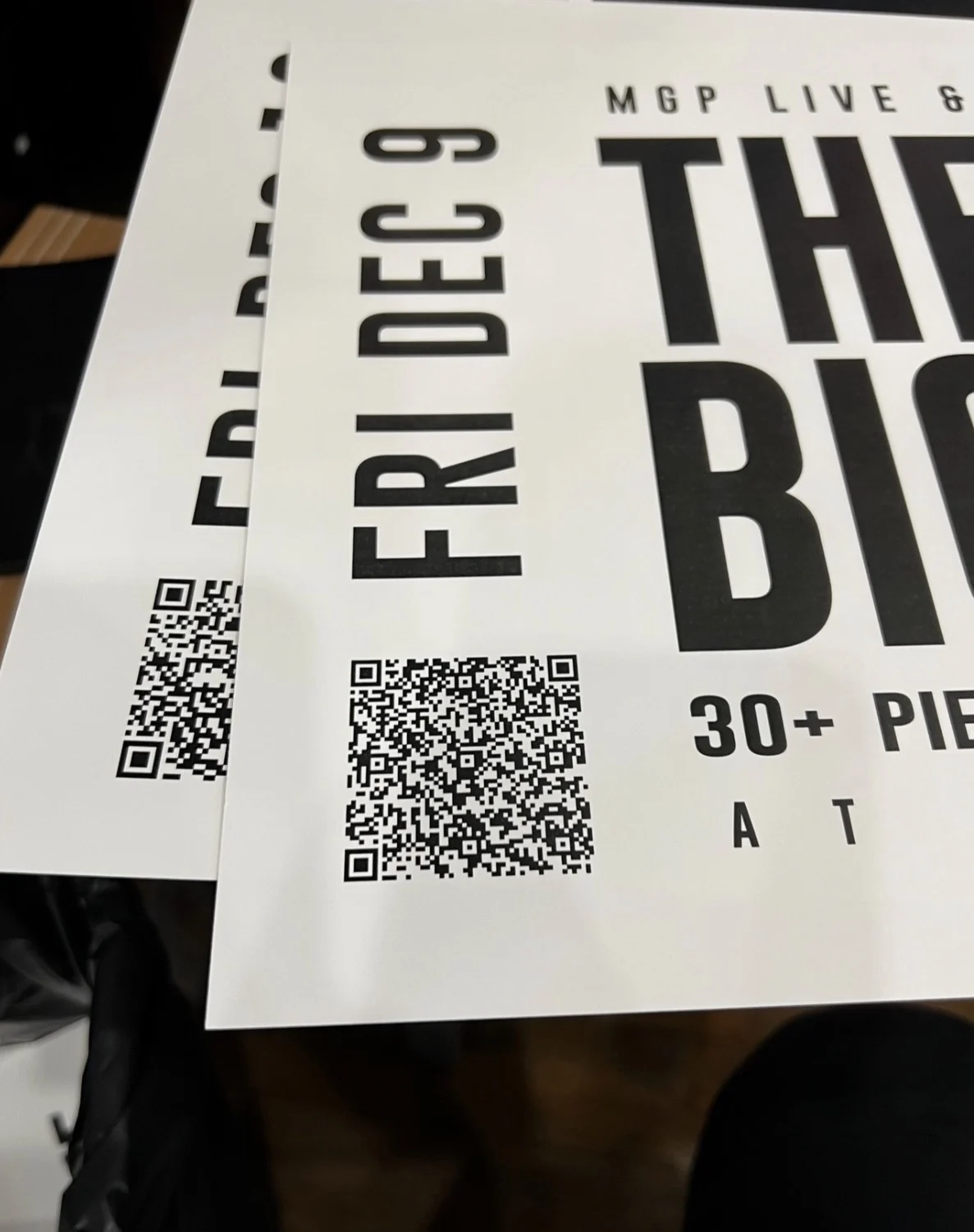 Printed billing cards stacked: Fri Dec 9, with QR code and large condensed type