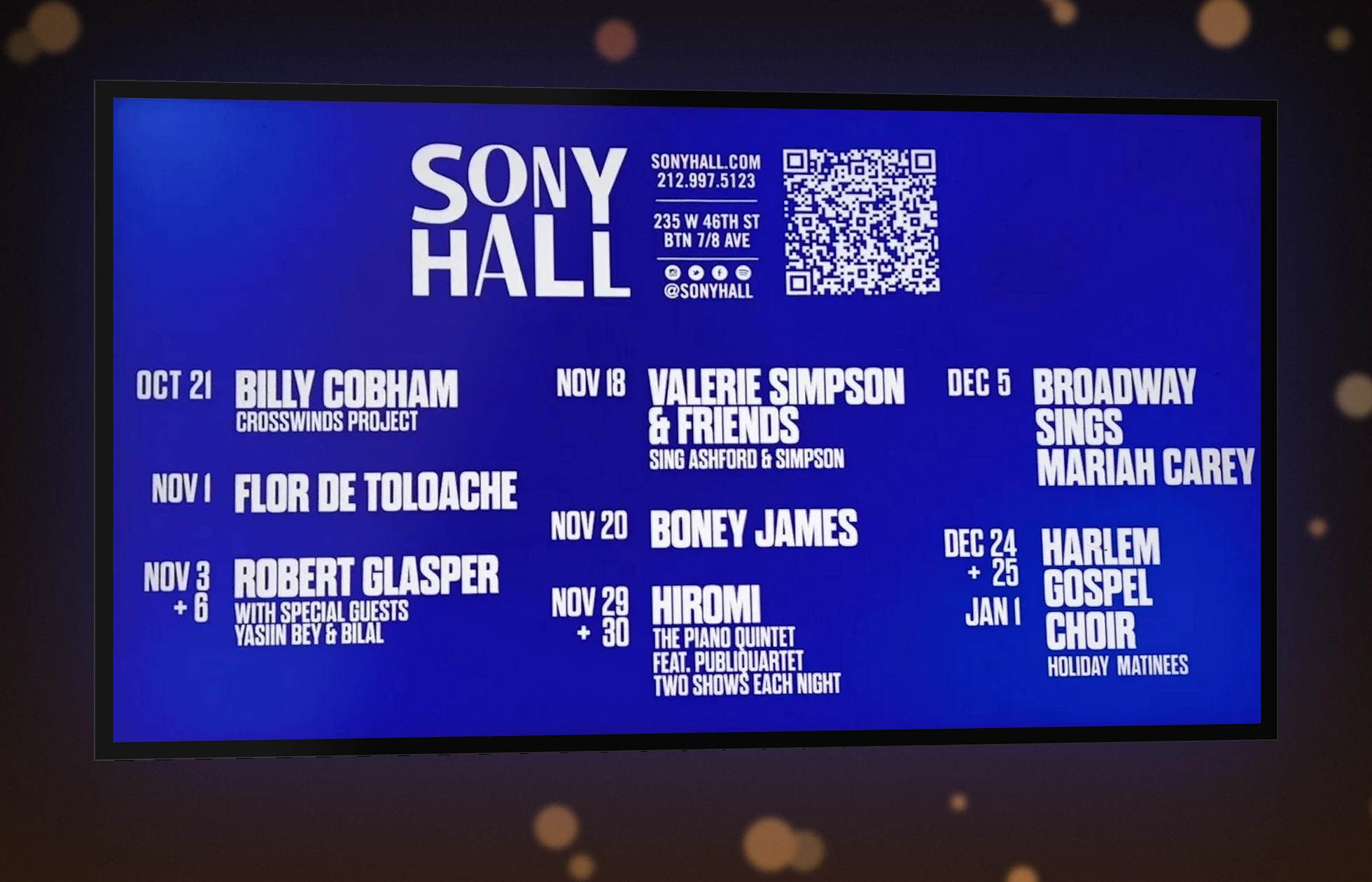 Lobby screen showing upcoming Sony Hall shows, mounted in the bar